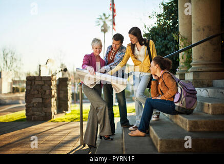 Colleagues discussing architectural plans together. Stock Photo