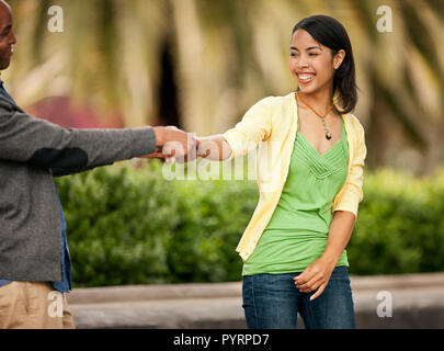 Young couple playfully holding hands. Stock Photo