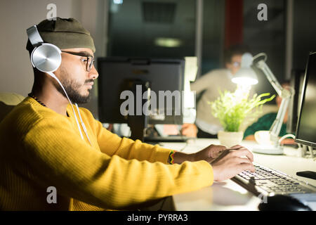 Computer Programmer Working Late Stock Photo