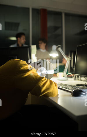 Young Man Sleeping at Workplace Stock Photo
