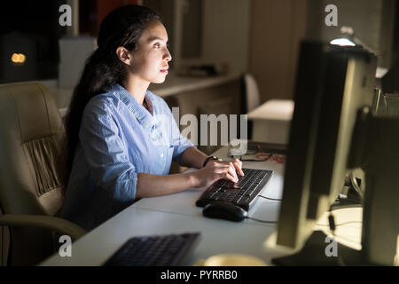 Businesswoman Working at Night Stock Photo