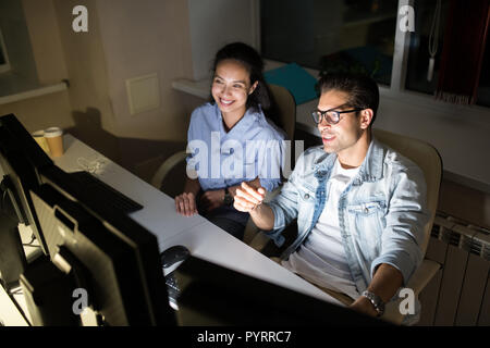 Colleagues Working at Night Stock Photo