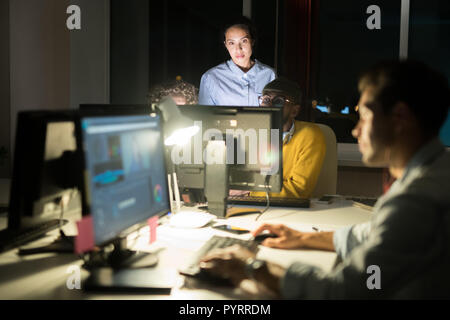 People Working in Dark Office Stock Photo
