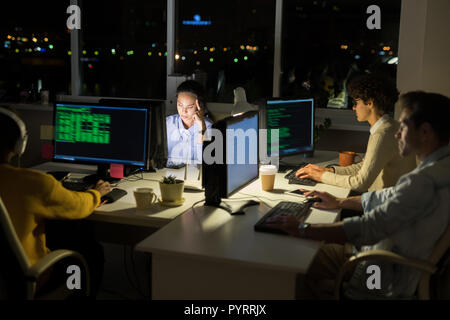 Computer Programmers Coding at Night Stock Photo