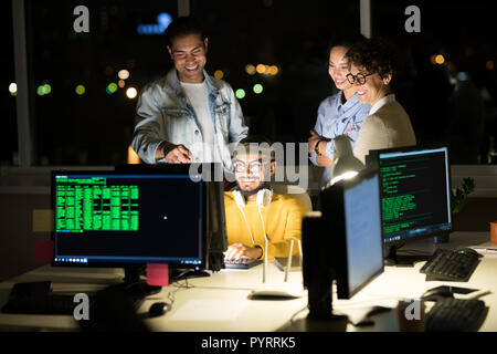 Computer Programmers Finishing Project a Night Stock Photo