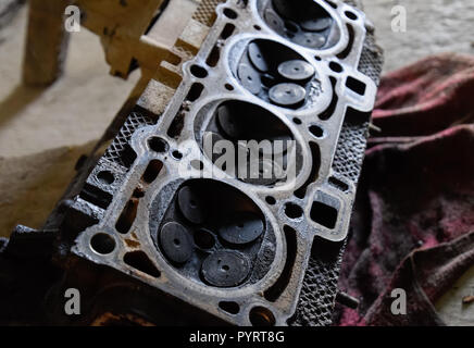 Valve in a deposit on the removed cover of the engine valve box. Stock Photo