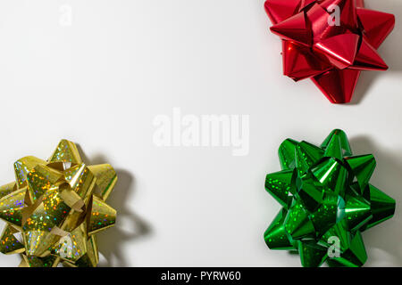 Christmas HolidaySatin Ribbon Bows, Gold, Red, Green. Light White Background. Room for copy. Stock Photo