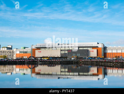 View of Ocean Terminal with H&M logo and Vue cinema logo reflected in the water of Victoria dock on a sunny day, Leith, Edinburgh, Scotland, UK Stock Photo
