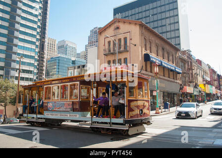 Public transportation. Famous San Francisco city's cable car with people close up running. Urban life style. Stock Photo