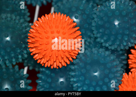 massage balls with flashing light effect, orange and blue prickly or therapy balls with flashlight reflections on them Stock Photo
