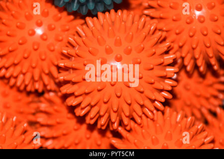 close-up view of orange massage or fascia balls without people, orange and blue prickly or therapy balls with flashlight reflections on them Stock Photo