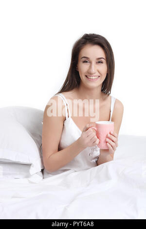 Pretty beautiful girl drinking in bed Stock Photo