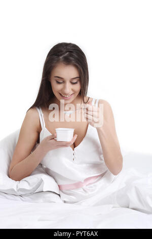 Beautiful young pretty woman having breakfast in bed Stock Photo