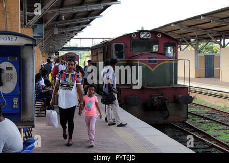 Translation: Passengers the station of Galle on the way to Colombo. Taken in Sri Lanka, August 2018. Stock Photo