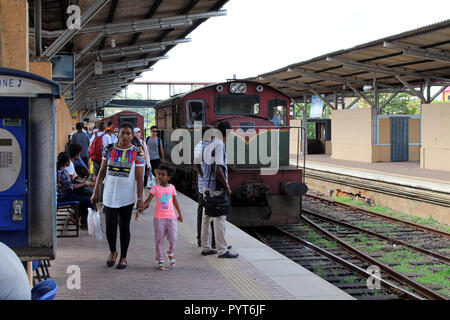 Translation: Passengers the station of Galle on the way to Colombo. Taken in Sri Lanka, August 2018. Stock Photo