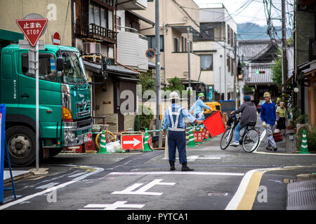 Japanese police is directing traffic on a junction Stock Photo