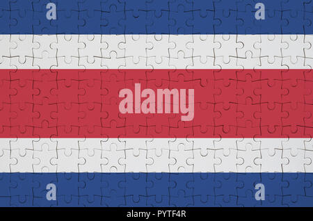 Costa Rica flag  is depicted on a folded puzzle Stock Photo