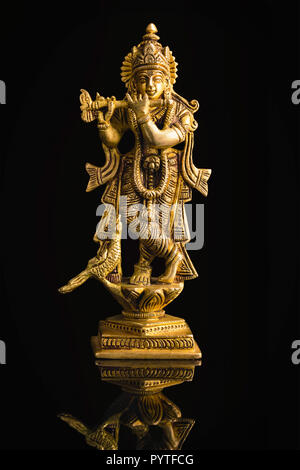 Krishna god Vishnu avatar brass statue isolated on black with reflection  Stock Photo - Alamy