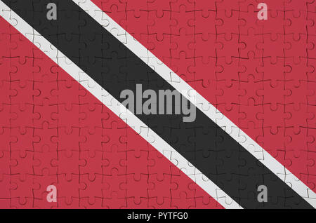 Trinidad and Tobago flag  is depicted on a folded puzzle Stock Photo