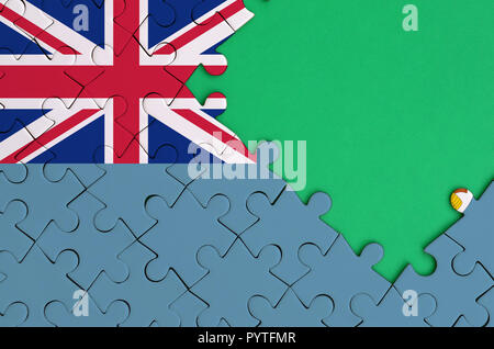 Fiji flag  is depicted on a completed jigsaw puzzle with free green copy space on the right side. Stock Photo