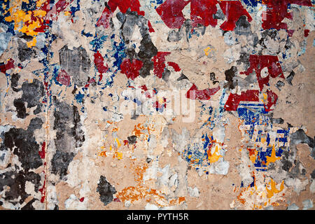 Bumpy plastered wall covered with mess of color spots and scratches Stock Photo