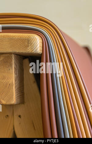 Pieces of leather in various colors on a workbench in a  design studio for handbags Stock Photo