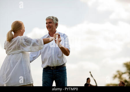 Happy mature couple dancing outside. Stock Photo