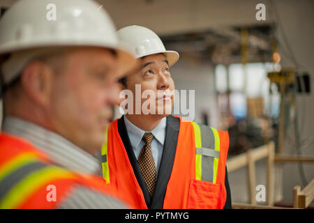 Middle aged businessman observing a construction site. Stock Photo
