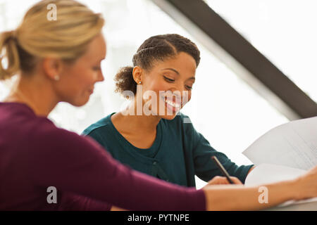 Happy colleagues working together on a project. Stock Photo