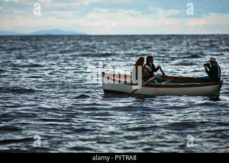 Couple being photographed on a row boat. Stock Photo