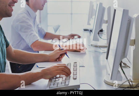 group of university students working on computers in campus classroom, education background Stock Photo