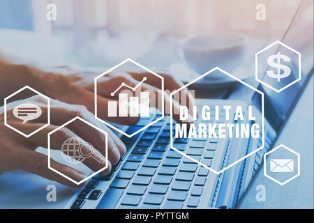 digital marketing icons, hands typing on keyboard as background Stock Photo
