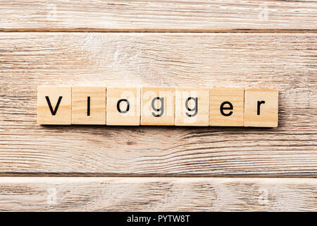 vlogger word written on wood block. vlogger text on table, concept. Stock Photo