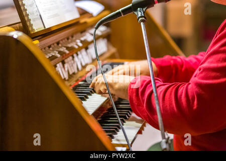 male hands playing organ keyboard in church Stock Photo