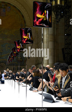 New York, USA. 30th Oct, 2018. People look at new Apple products during a launch event in Brooklyn, New York, the United States, on Oct. 30, 2018. Apple Inc. on Tuesday launched its new iPad Pro, MacBook Air and Mac mini at an event in Brooklyn, New York City, offering long-awaited updates to some of its popular devices. Credit: Xinhua/Alamy Live News Stock Photo