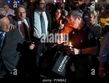 Miami Beach, FL, USA. 30th Oct, 2018. Sandy and Jessie Bernstein comfort each other during an interfaith memorial service and solidarity vigil against anti-Semitism and hate at the Holocaust Memorial in Miami Beach Tuesday, October 30, 2018, in the aftermath of the shooting of the Tree of Life Synagogue in Pittsburgh. Mike Stocker, South Florida Sun-Sentinel Credit: Sun-Sentinel/ZUMA Wire/Alamy Live News Stock Photo