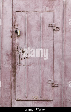 Texture of the surface of a rusty metal garage with cracked paint Stock Photo