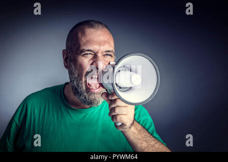 portrait of caucasian man with megaphone studio shot Stock Photo