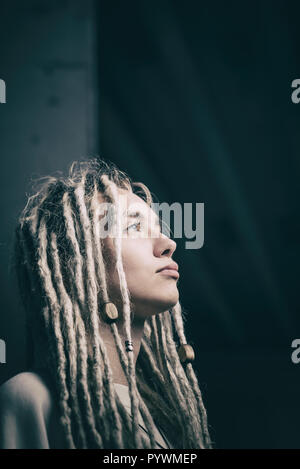 Beautiful young woman with blonde dreadlocks hairstyle portrait Stock Photo