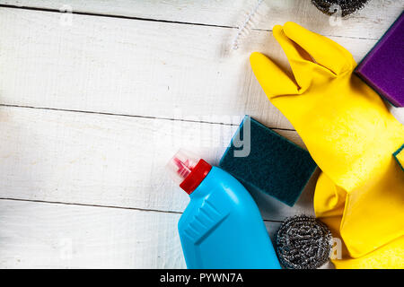 Items for home or office cleaning on a white wooden background. Stock Photo