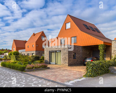 Modern architecture houses with remarkable red roof tiles in a contemporary suburban neighborhood in the Netherlands Stock Photo