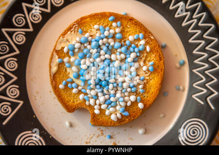 Rusks with white and blue anise seed sprinkles served in Holland when a baby is born, on a white background Stock Photo