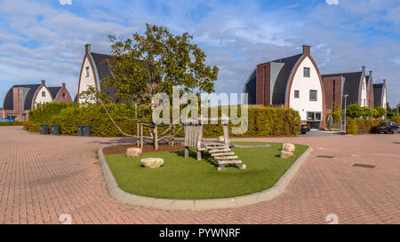 Remarkable modern suburban family houses in a child-friendly  neighborhood with trees and playground Stock Photo