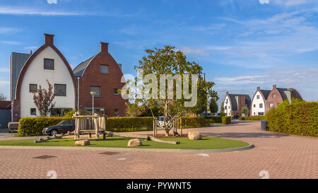 Conspicious modern suburban family houses in a child-friendly  neighborhood with trees and playground Stock Photo