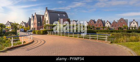 Suburban area with modern family houses in a child-friendly  neighborhood with trees and gardens Stock Photo