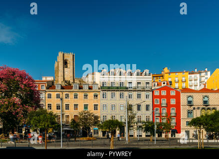 Lisbon, Portugal - Oct 24, 2018: Traditional buildings with azulejo tiles in the old Lisbon neighbourhood of Alfama with Se Cathedral in background Stock Photo