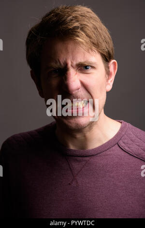 Portrait of handsome man against gray background Stock Photo