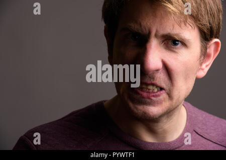 Portrait of handsome man against gray background Stock Photo