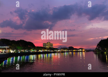 Twilight on the Sarawak river with Kuching cityscape, Borneo, Malaysia Stock Photo