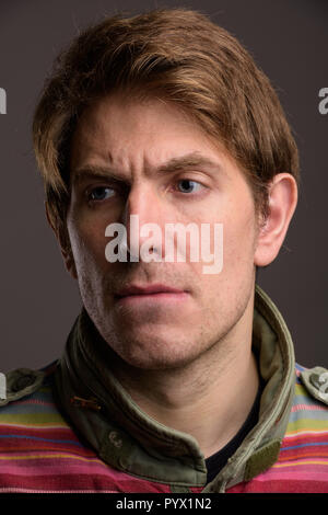 Portrait of handsome man against gray background Stock Photo